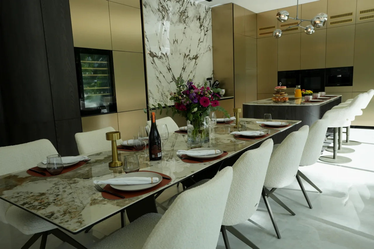 Kitchen with a long natural stone dining table