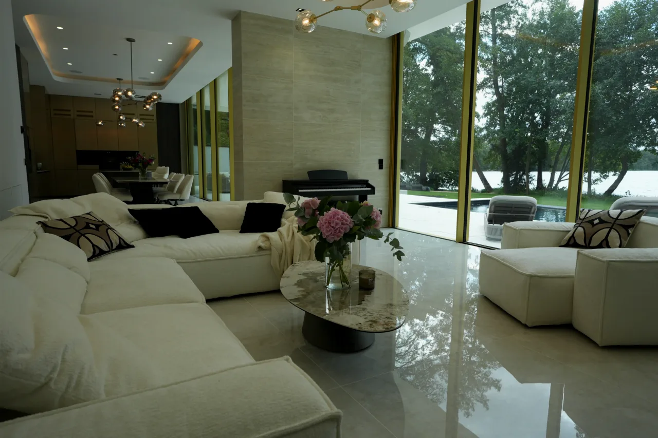 Living area with floor-to-ceiling glass and a view of the lake
